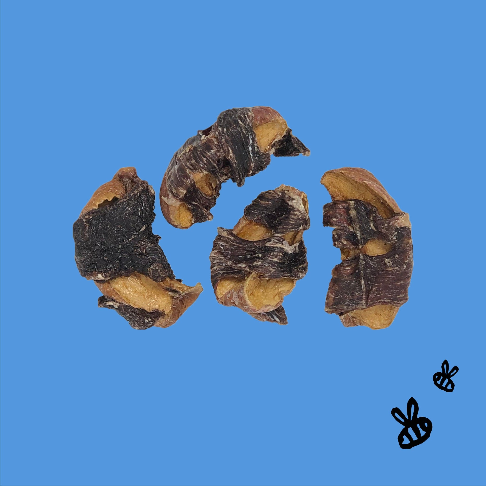four buffalo wrapped apple jerky treats on bright blue background, two black bees, bottom right