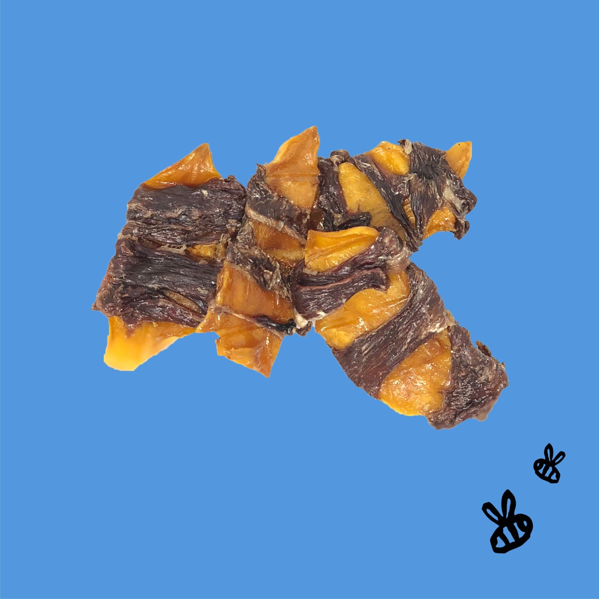 four pieces of mango wrapped in buffalo jerky on a blue background, two black bees on bottom right